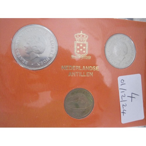 4 - One Plastic Tub Containing an Assortment of Mixed Coinage And A Set Of Three Coins In Orange Display... 