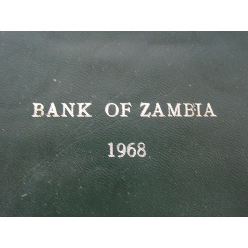 6 - A Tin Containing Mixed Coinage And Two Bank Of Zambia Coins Each In A Plastic Case and A Bank Of Zam... 