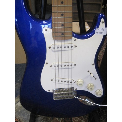 63 - A Squire Strat by Fender Affinity Series six-string electric guitar, with a stand and a Park G10 amp... 