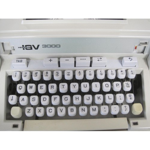 25 - An Hermes IGV 3000 manual typewriter with carry case and instruction manual, and a Facit CA1-13 elec... 