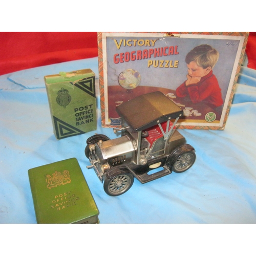 26 - A vintage radio in the form of a classic car, a Victory jigsaw puzzle and a metal Post Office Saving... 