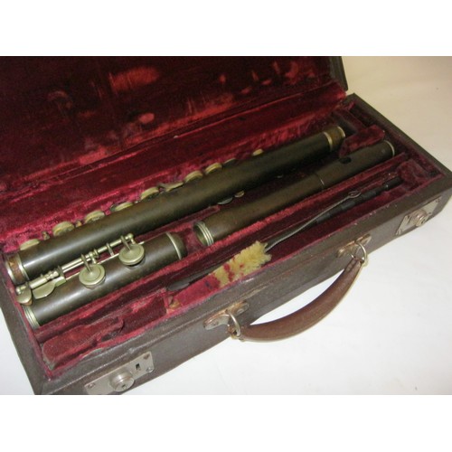 140 - A cased flute made of Bakelite or similar, complete, with cleaning rod