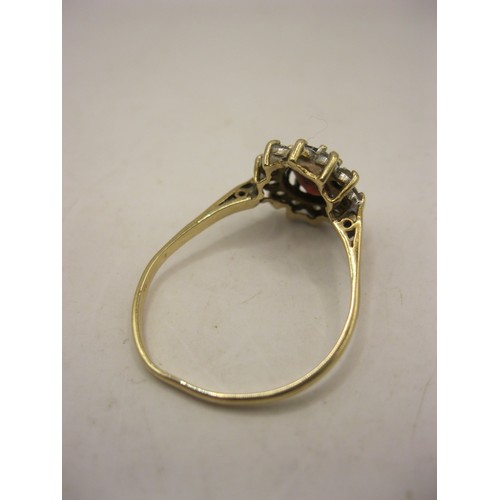 185 - A 9 carat gold ring with large central ruby surrounded by a cluster of 1 dozen small clear stones, v... 