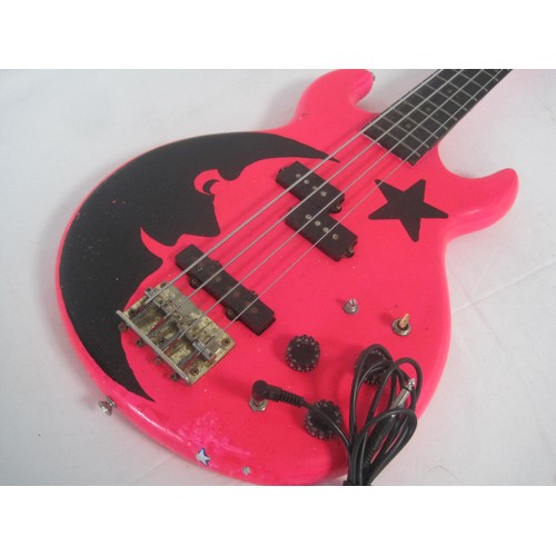 169 - A pink bass guitar with lead