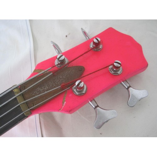 169 - A pink bass guitar with lead