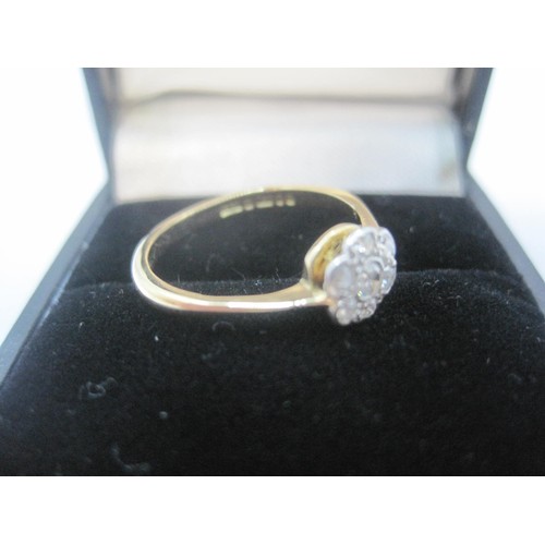 217 - An 18 carat gold diamond flower ring, central diamond surrounded by 6 smaller diamonds, ring size J,... 