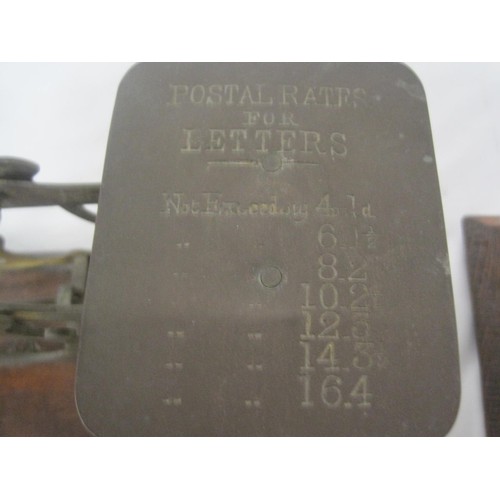 227 - Three brass postage scales mounted on mahogany and oak, together with brass weights. One balance mar... 