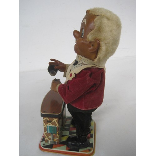 33 - A 1950s tin plate automaton of a bartender made by TN in Japan, overall good order but missing bottl... 