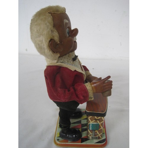 33 - A 1950s tin plate automaton of a bartender made by TN in Japan, overall good order but missing bottl... 