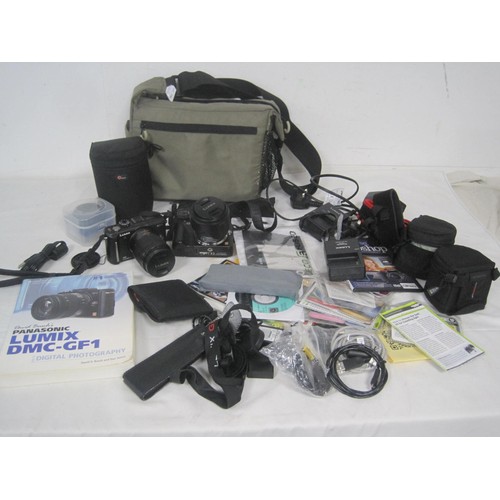 240 - Two Panasonic Lumix digital cameras with lenses, Nissin flash, and accessories, in a camera bag. (Th... 