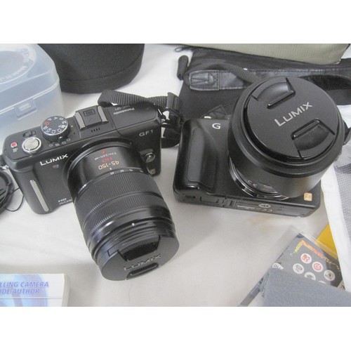 240 - Two Panasonic Lumix digital cameras with lenses, Nissin flash, and accessories, in a camera bag. (Th... 