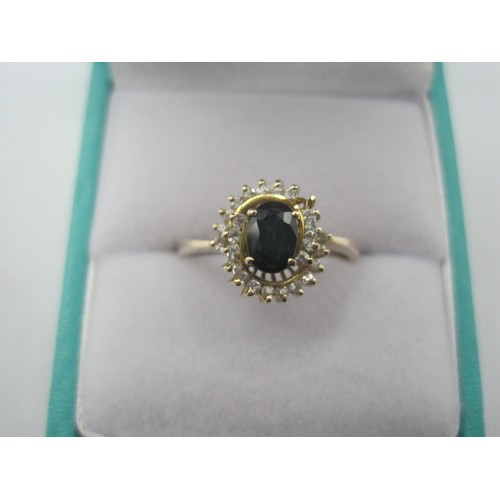 257 - A 14 carat gold sapphire and white stone ring, the central sapphire estimated at 6mm x 4mm, in a swi... 