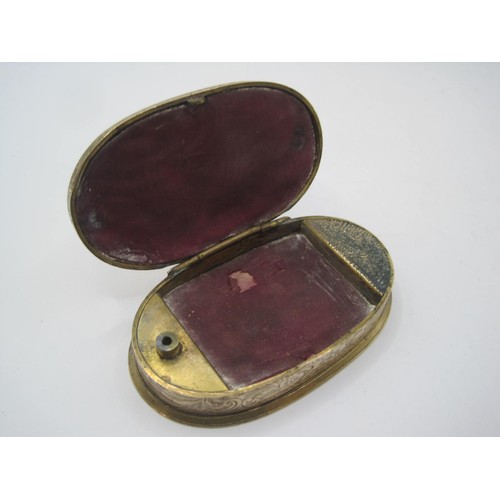 265 - A gilt brass Go to Bed vesta case of oval shape with foliate engraving, the interior lined with red ... 