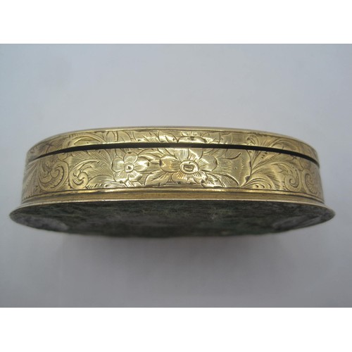 265 - A gilt brass Go to Bed vesta case of oval shape with foliate engraving, the interior lined with red ... 