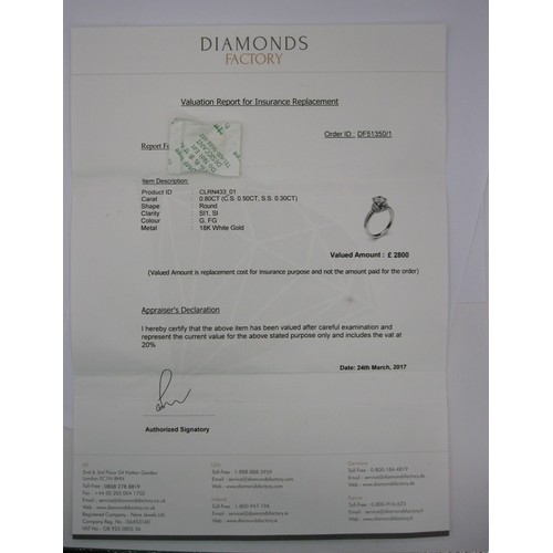 36 - An 18 carat white gold solitaire diamond ring. The central stone estimated at 0.5 carat, with furthe... 