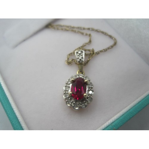 270 - An oval ruby and white stone pendant on a fine gauge chain. The pendant with 375 import marks, the c... 