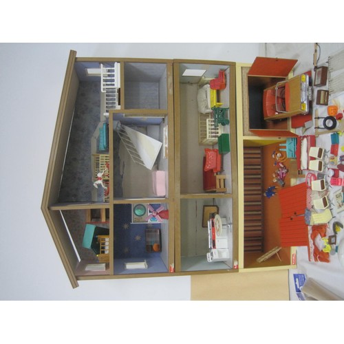 272 - A Lundby dolls house with garage unit, a large quantity of furniture and accessories, several dolls ... 