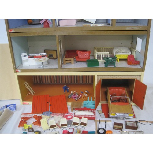 272 - A Lundby dolls house with garage unit, a large quantity of furniture and accessories, several dolls ... 