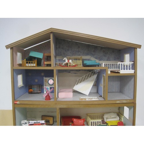 272 - A Lundby dolls house with garage unit, a large quantity of furniture and accessories, several dolls ... 