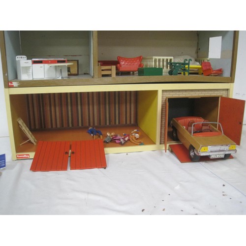 272 - A Lundby dolls house with garage unit, a large quantity of furniture and accessories, several dolls ... 