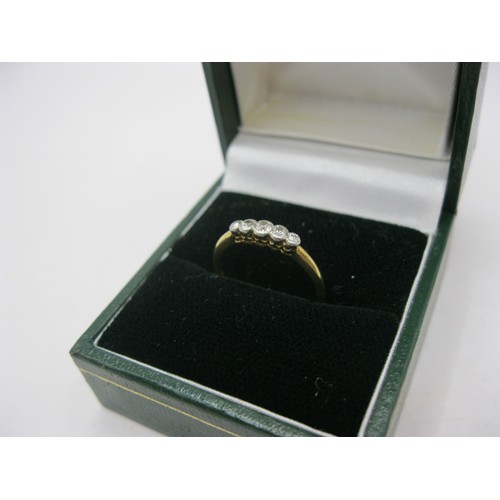 73 - An 18 carat gold ring set with a row of five graduated diamonds, ring size M, gross weight of ring a... 