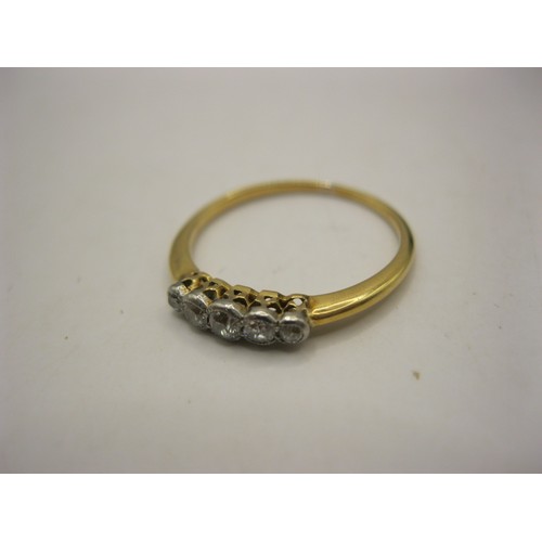 73 - An 18 carat gold ring set with a row of five graduated diamonds, ring size M, gross weight of ring a... 