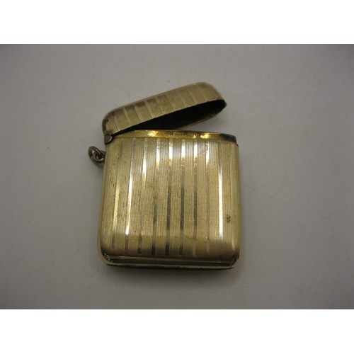 76 - A gold-plated vesta of traditional shape with engine turned bands, inner edge stamped ROLLED GOLD SP... 