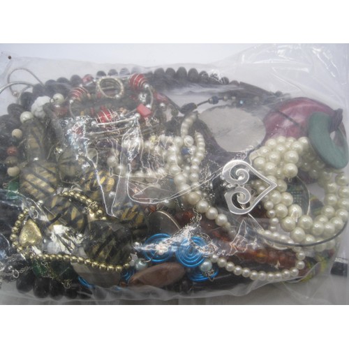 282 - Bag of assorted costume jewellery including beaded bangles, etc