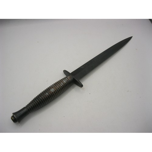 24 - A Fairburn Sykes Mark III Commando dagger with scabbard, ribbed metal hilt, in good order