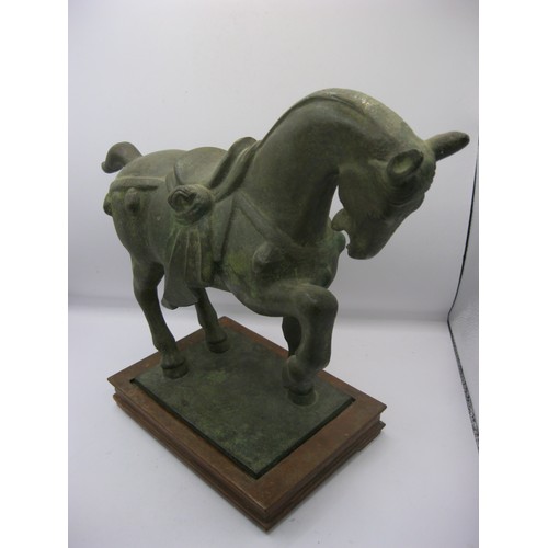 28 - A heavy Oriental style bronze of a rearing horse on a wooden stand, in good order