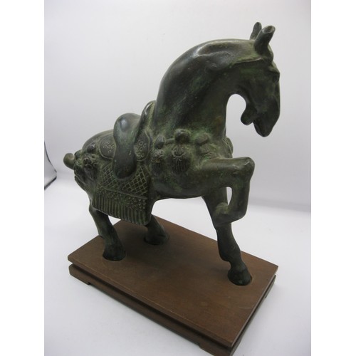 29 - A large Tang style Oriental bronze horse, heavy, mounted on a wooden base