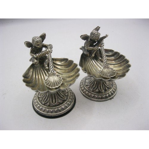 31 - A pair of foreign silver scallop and cherub salts with matching spoons. Height about 52mm, one salt ... 