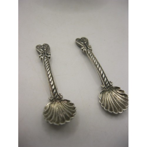 31 - A pair of foreign silver scallop and cherub salts with matching spoons. Height about 52mm, one salt ... 