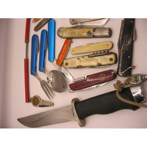 32 - A tin containing a quantity of penknives including a folding knife, fork and spoon set, a military s... 