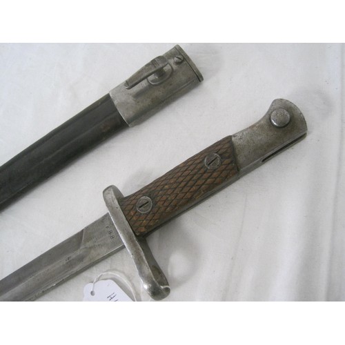 348 - A Spanish M1913 bayonet with chequered wooden grips in its leather scabbard with steel mounts. Marke... 