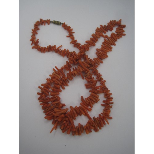 74 - A long salmon coloured coral necklace