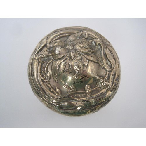 126 - An Art Nouveau silver lidded jar embossed with floral scene, hallmarked for Chester 1909