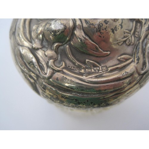 126 - An Art Nouveau silver lidded jar embossed with floral scene, hallmarked for Chester 1909