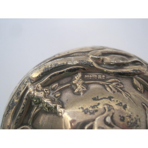 126 - An Art Nouveau silver lidded jar embossed with floral scene, hallmarked for Chester 1909