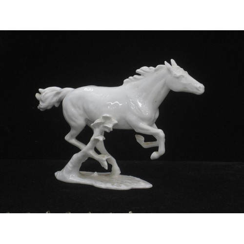 50 - A Kaiser white porcelain figure of a Galloping Horse