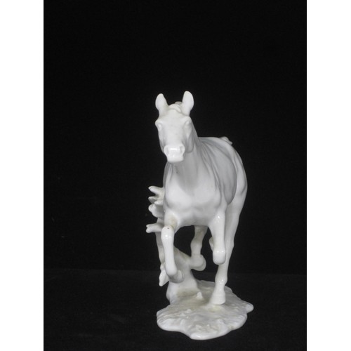 50 - A Kaiser white porcelain figure of a Galloping Horse