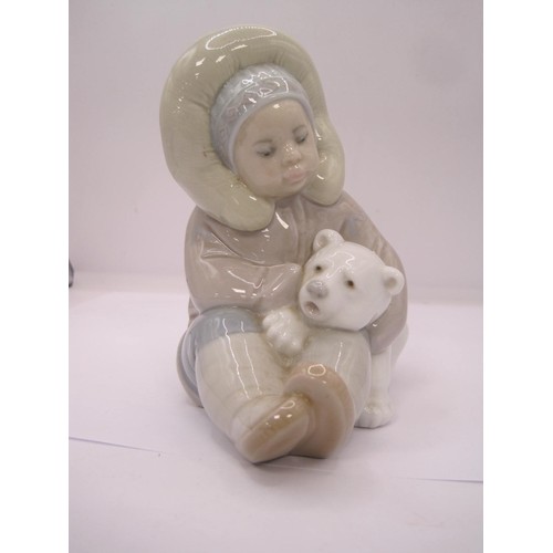 52 - Lladro figurine of an Eskimo Boy and Polar Bear Cub, together with a large Lladro figure of a Clown ... 