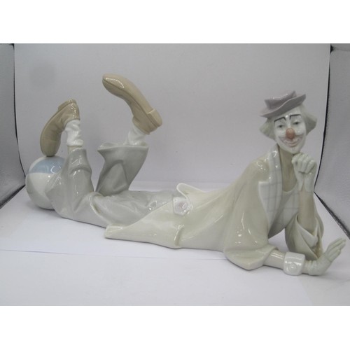 52 - Lladro figurine of an Eskimo Boy and Polar Bear Cub, together with a large Lladro figure of a Clown ... 