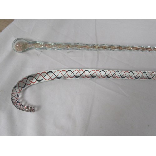 132 - Two glass walking canes, examples of the glassmaker's art. One twisted coloured cane, the other fill... 