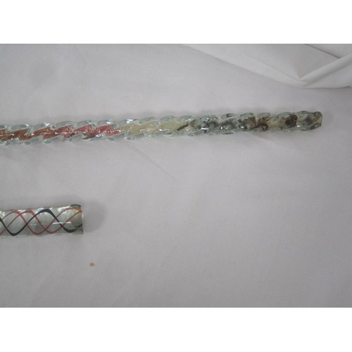 132 - Two glass walking canes, examples of the glassmaker's art. One twisted coloured cane, the other fill... 