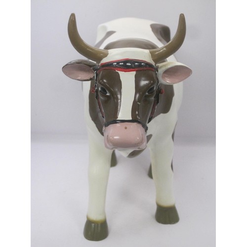 145 - A decorative resin dairy cow, likely an advertising piece of Continental origin, hand painted detail... 