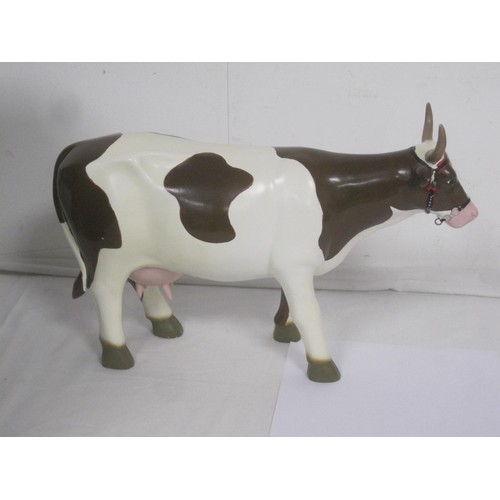 145 - A decorative resin dairy cow, likely an advertising piece of Continental origin, hand painted detail... 