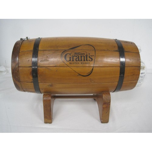 146 - A wooden Grant's Whiskey bottle holder in the form of a barrel, with stand, and a Bowmore ceramic de... 