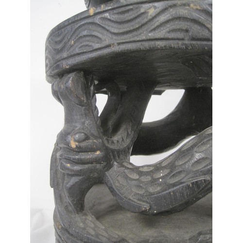 148 - A heavily carved hardwood planter, the stand formed of dragons