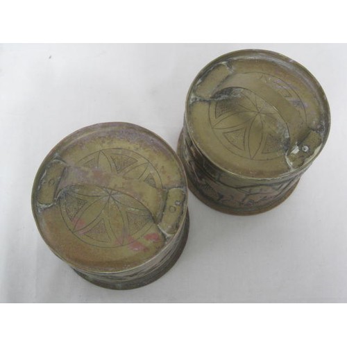 144 - A pair of 1918-dated Trench Art shell cases formed as lidded pots, one decorated with a hunting dog ... 